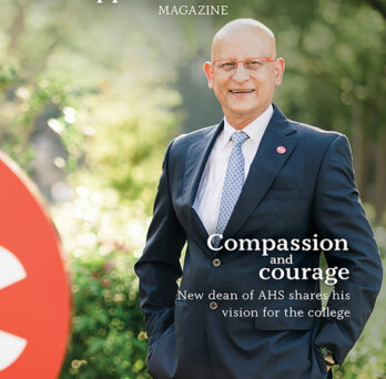 Cover of 2022 issue of AHS magazine depicting dean Carlos Crespo standing outside in front of a verdant background
                  