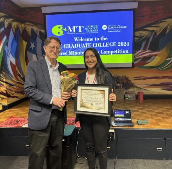 Aditi holding the 2024 3MT award certificate presented by the dean of the UIC Graduate College who stands next to her holding a bouquet of flowers
                  