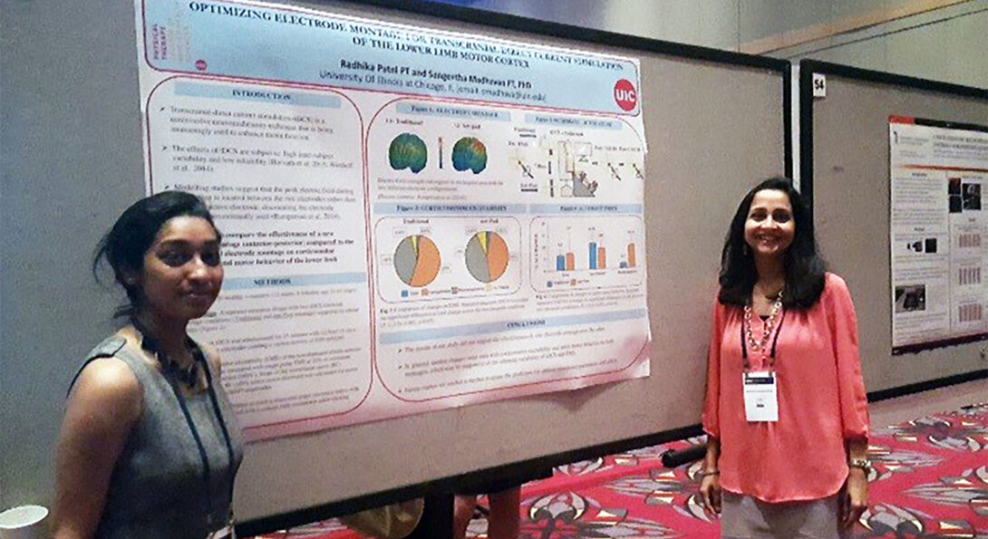 Two women in front of research presentation