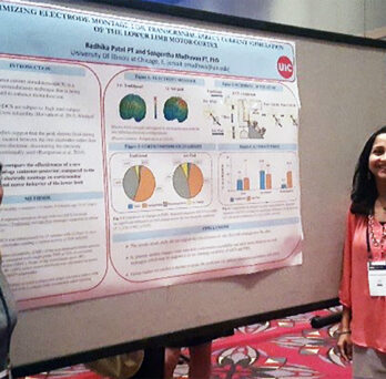 Two women in front of research presentation
                  