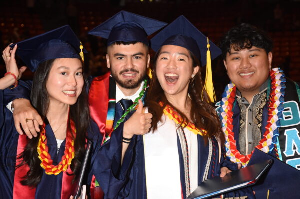 Graduate wearing blue cap and gown