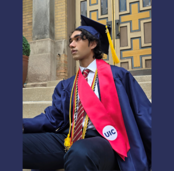 Student sits on outdoor steps wearing a navy graduation cap and gown, gold honor cords, and a red UIC stole.
                  