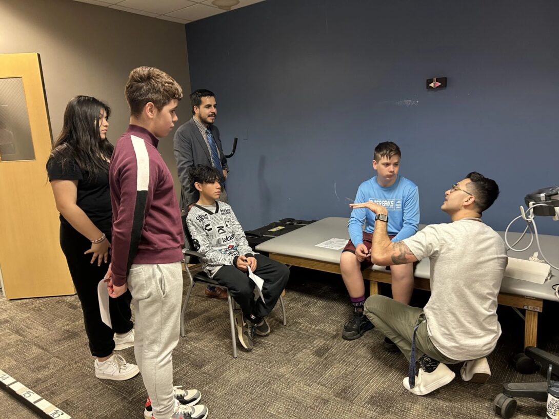 Steven Garcia, KN postdoctoral research associate and member of the the UIC Biomechanics and Clinical Outcomes Lab, leads an ultrasound activity with a group of Altus eighth-graders.