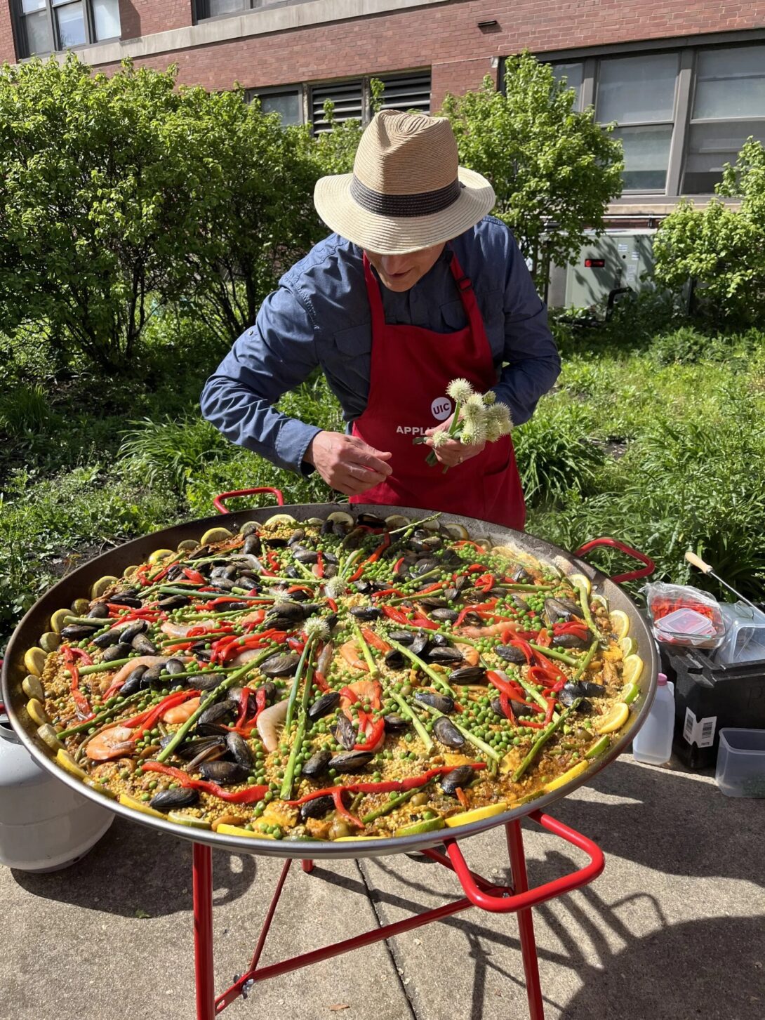 Dean Carlos Crespo adds the finishing touches to the paelle.