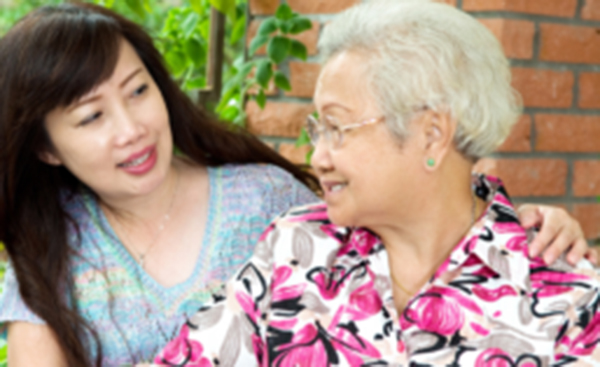 A middle-aged woman embraces an older woman while looking at one another