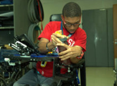 person with wheelchair using tool