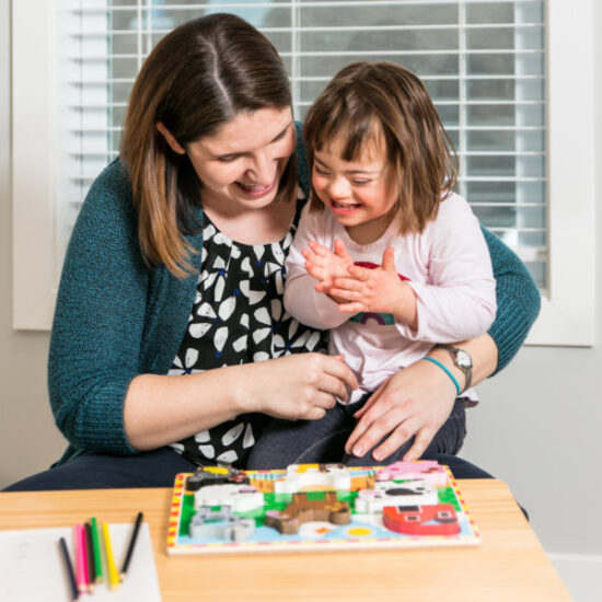 Woman completing a puzzle with a child