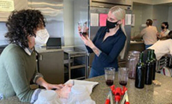 Nutrition students are performing a sensory evaluation of the wine they just produced from the previous class; on the side, are two jars of tea with SCOBY to make kombucha.