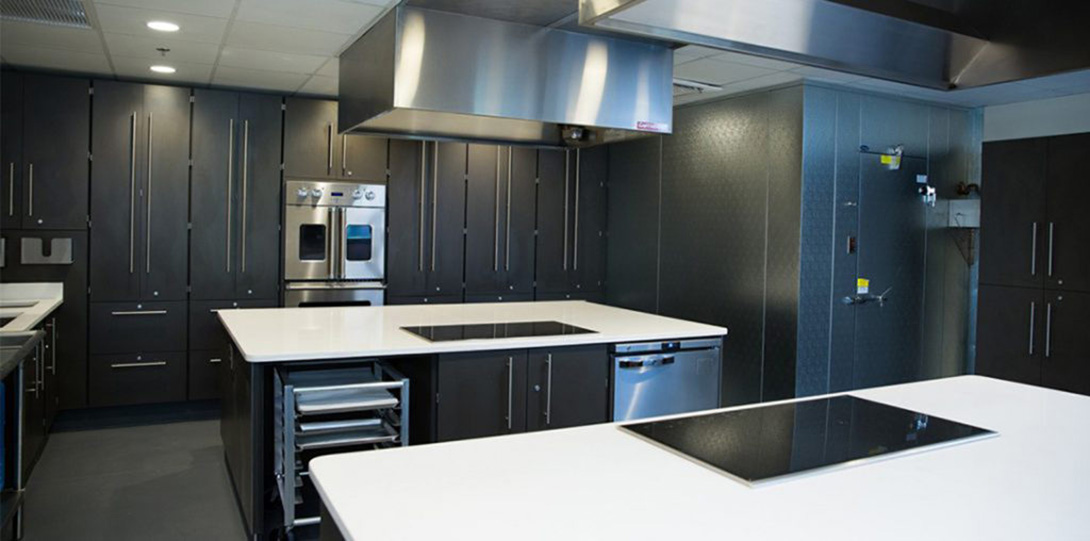 Kitchen with black cabinets and white counters