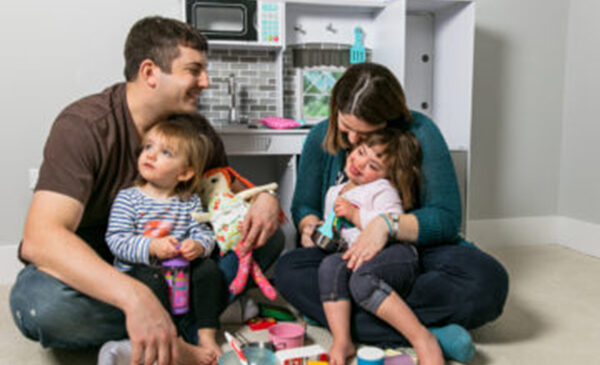 Two adults sitting with two children