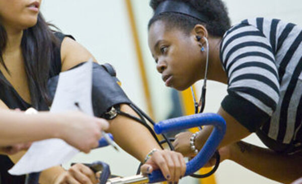 student checking blood pressure