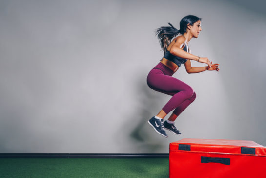 Woman jumping on box