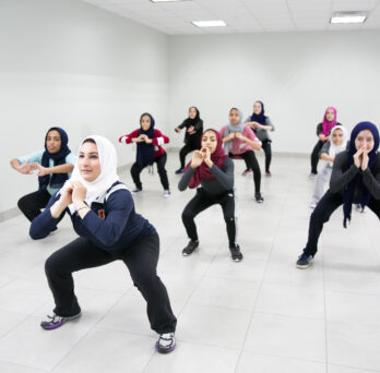 Rhonda Atallah leads a group of Muslim girls in a group exercise
                  