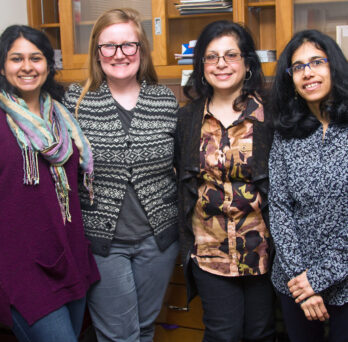 Grad students (from left) Vineeta Ram and Kathryn B. Duke work on the PRIDE project with researchers Rooshey Hasnain and Mansha Mirza. ­
                  