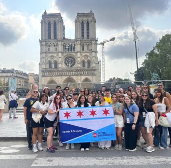 A group of UIC students stand in front of Notre Dame holding a UIC Global Engagement banner
                  