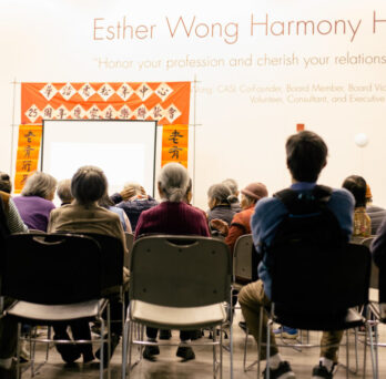 Photo of a group of elderly Asian Americans sitting in chairs
                  