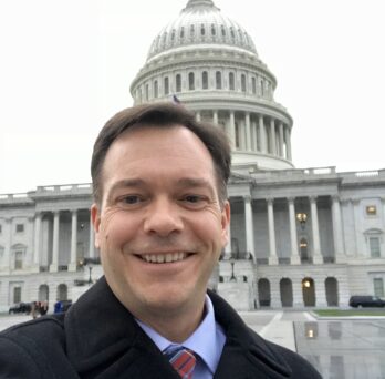 Joe Caldwell in front of the US Capitol Building
                  