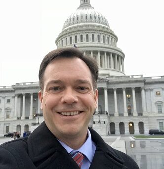 Joe Caldwell in front of the US Capitol Building
                  