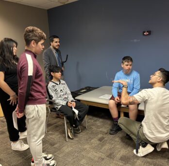 Steven Garcia, KN postdoctoral research associate and member of the the UIC Biomechanics and Clinical Outcomes Lab, leads an ultrasound activity with a group of Altus eighth-graders.
                  