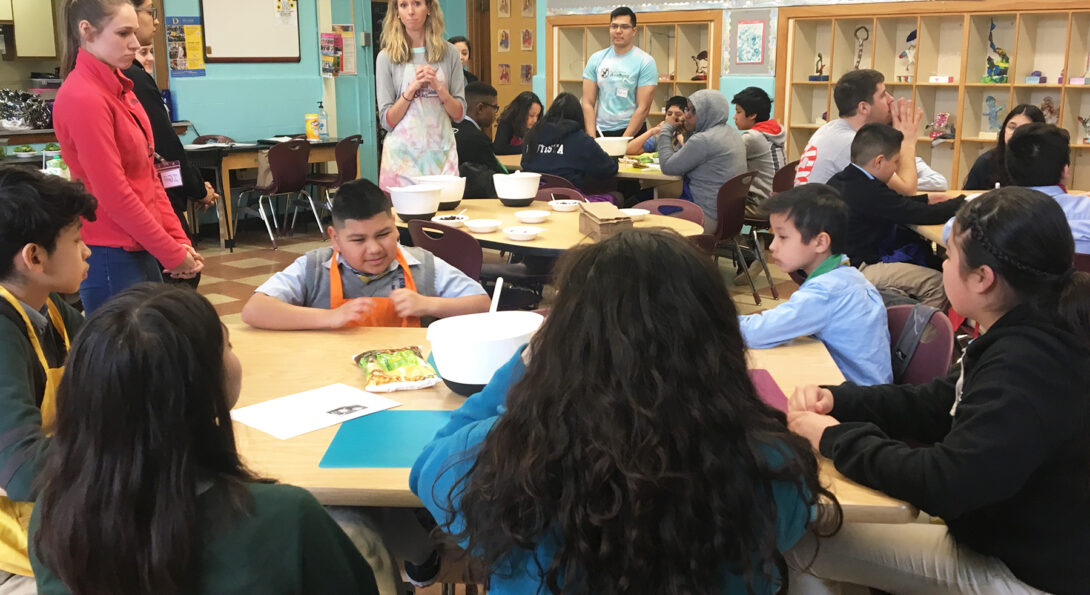 UIC clinical instructor Lindsey Strieter (center) talks to a group of Altus Academy students during a lesson on breakfast in the UIC Health and Wellness Academy.