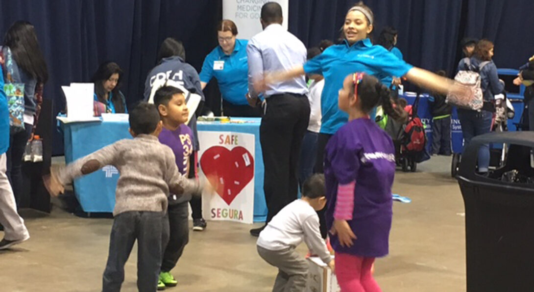 Rehabilitation sciences student Korynna Pepin leads a group of children in an exercise session.