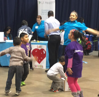 Rehabilitation sciences student Korynna Pepin leads a group of children in an exercise session.
                  