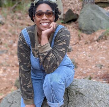 Khorizon Dunn sits on a large boulder
                  