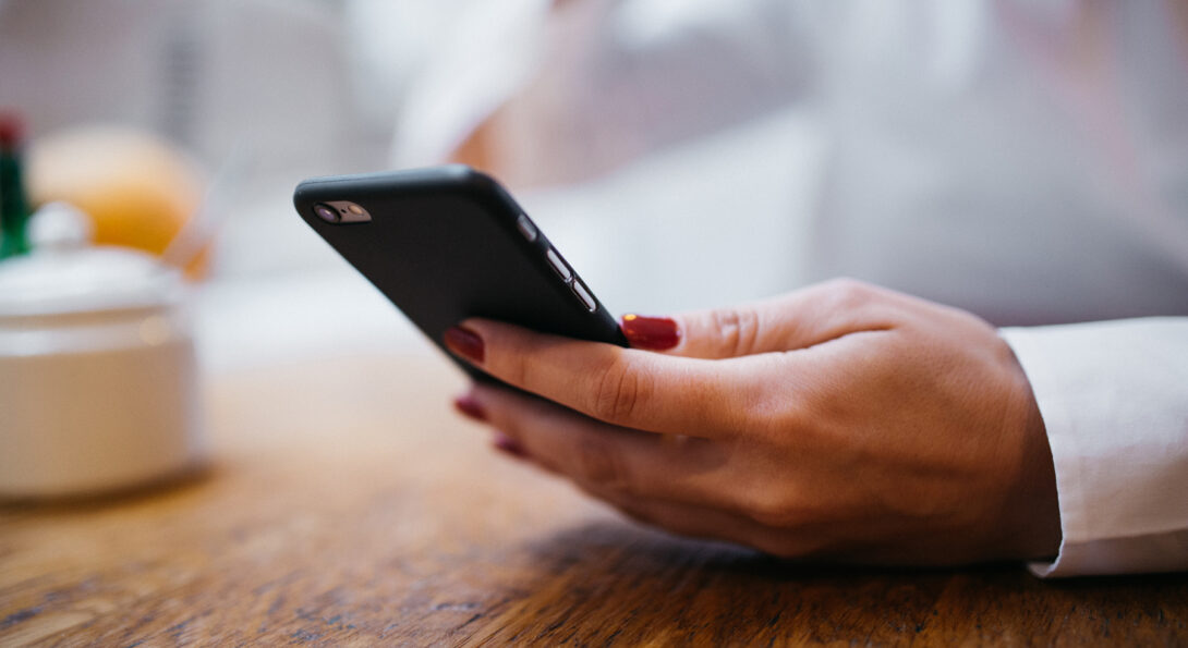 Image of woman's hand holding a smart mobile phone