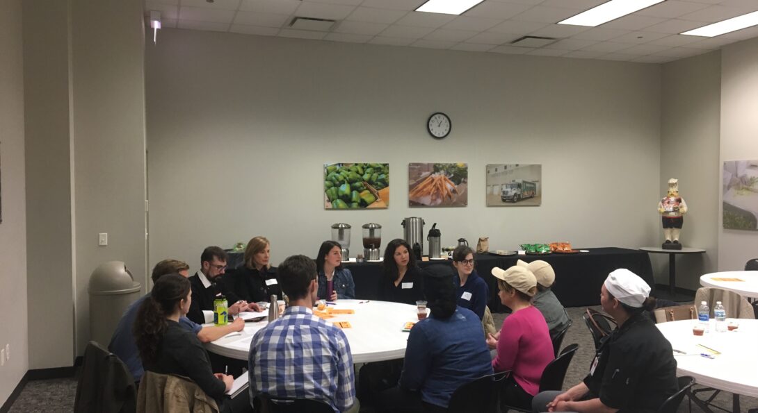 Small group discussions with nutrition and medical students, and participants in the Chicago Community Kitchens program, which trains unemployed and underemployed individuals to work in food service around a circular table.