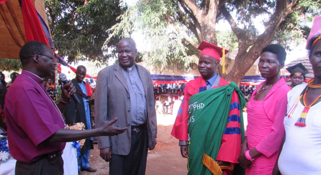 When he returned to Uganda, his village held a graduation celebration with decorations in UIC colors for Patrick Ojok, shown here with his wife, Akidi Florence.