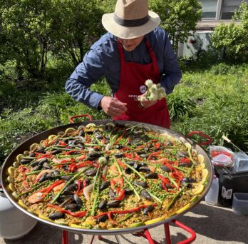 Dean Carlos Crespo adds the finishing touches to the paelle.
                  