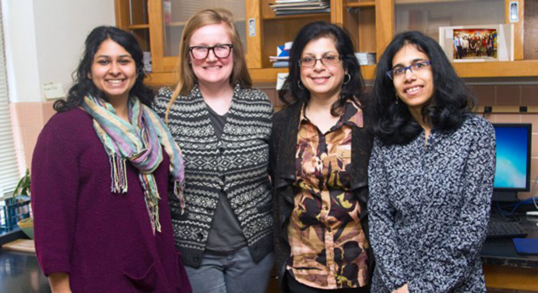 Grad students (from left) Vineeta Ram and Kathryn B. Duke work on the PRIDE project with researchers Rooshey Hasnain and Mansha Mirza.