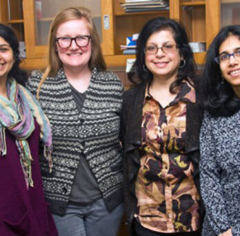 Grad students (from left) Vineeta Ram and Kathryn B. Duke work on the PRIDE project with researchers Rooshey Hasnain and Mansha Mirza.
                  