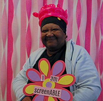 ScreenABLE attendee holding a sign that reads 