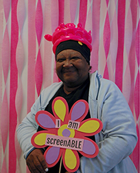 ScreenABLE attendee holding a sign that reads 