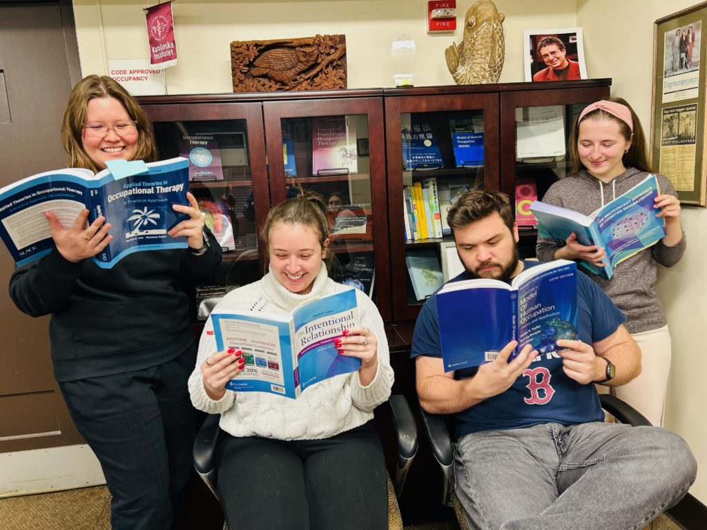 Four members of the Theory and Evidence-Based Practice Related to Human Occupation SOPC reading books