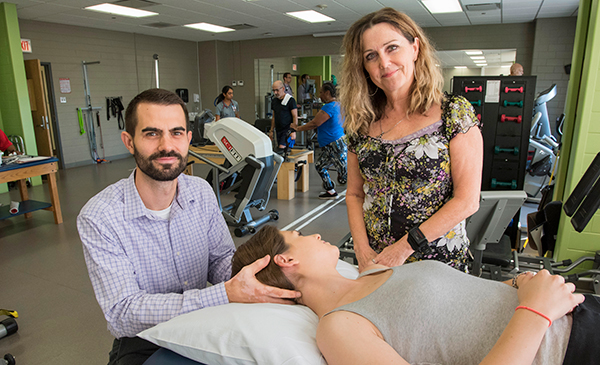 Physical therapists holding head of patient