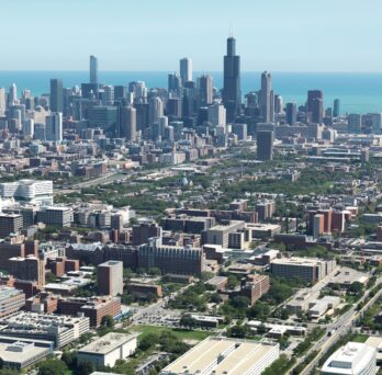 Aerial view of the UIC west campus with the Chicago skyline and Lake Michigan in the background
                  