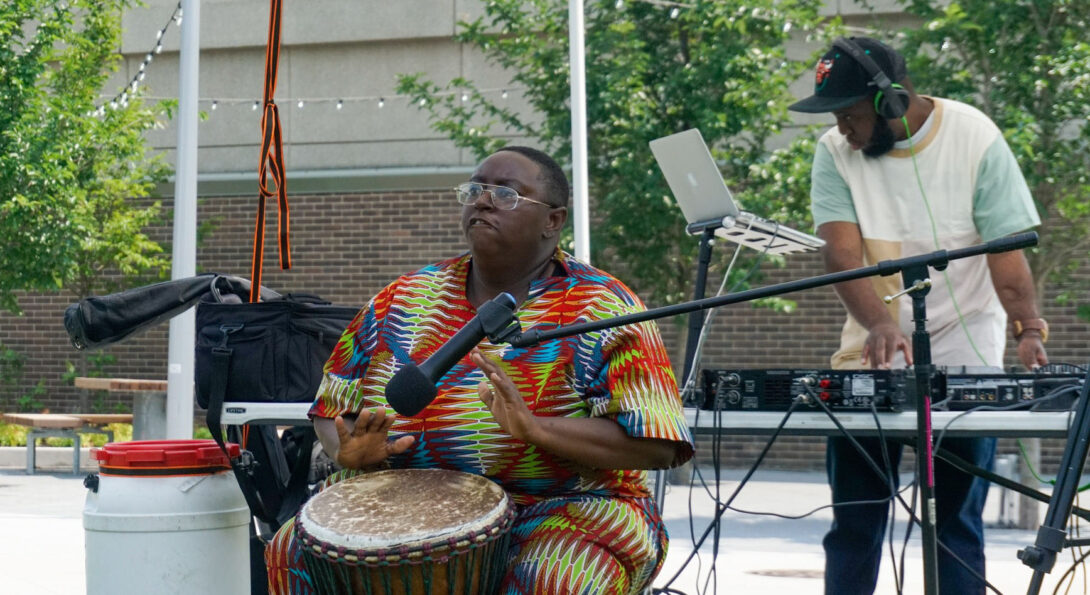 Victoria Boateng plays the djemba while Matt Morgan deejays. Boateng is a teacher and performer of West African drums, including the djembe and dununs.