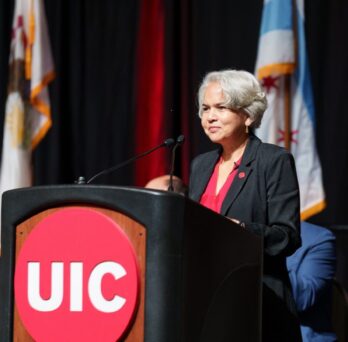 Marie Lynn Miranda stands behind a podium
                  