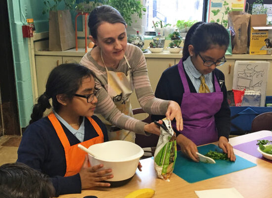 Woman cooking with two children