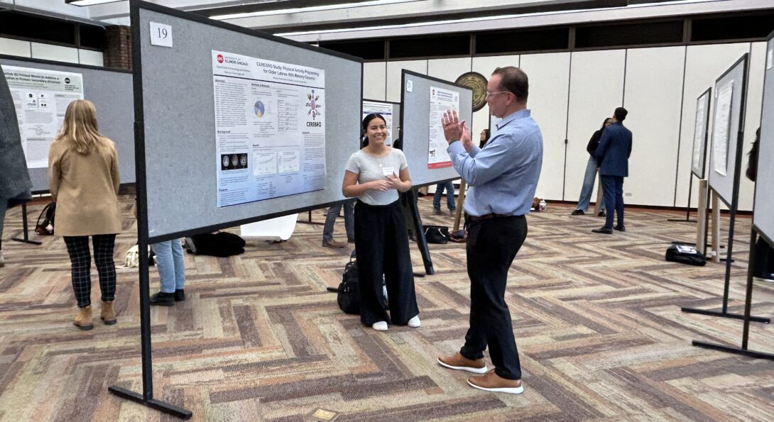 David Marquez and Mariana Pinto discussing a research poster during AHS Research Day.