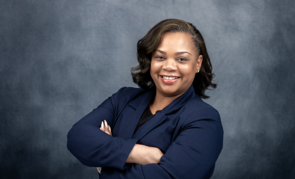 Shanita Jones smiling at the camera in formal attire.