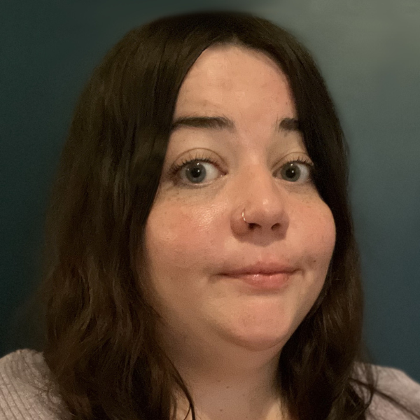 Women with dark brown hair looking at camera.