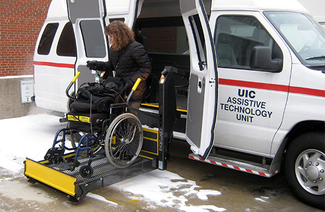 a woman leaving a van using a wheelchair lift