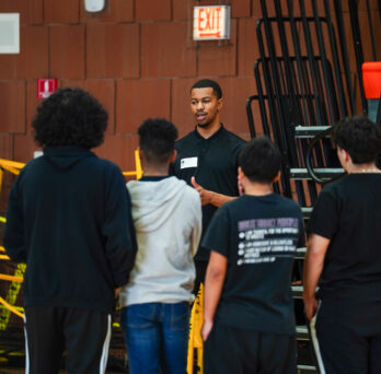 Kinesiology graduate student Kai Bates-Diop delivers a sport psychology workshop to a group of high school student athletes.
                  