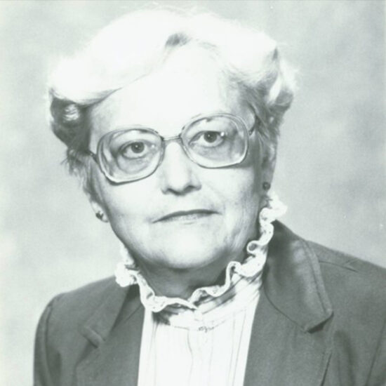 Barbara Loomis headshot, black and white photo of a woman in glasses