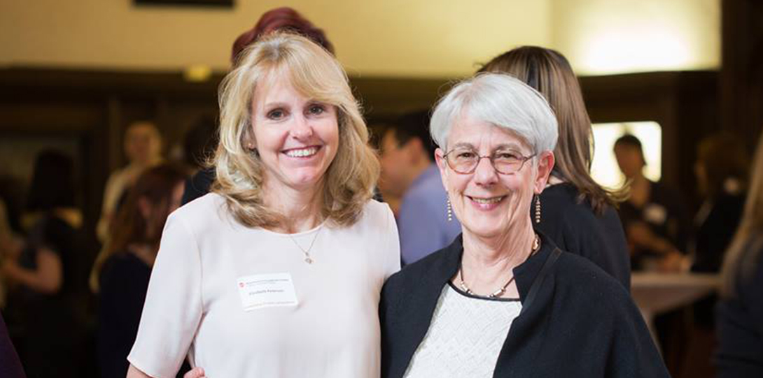 Two women smiling at the camera.