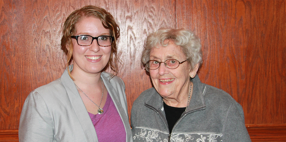 Two women standing and smiling at the camera
