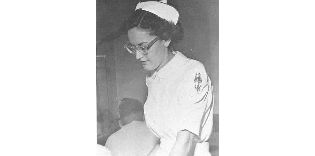 A black and white image of a woman in a nurse's uniform